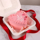 I Love You Mini Vanilla Cake in heart shape with pink frosting and red ribbon, ideal for romantic birthday or anniversary gifts.